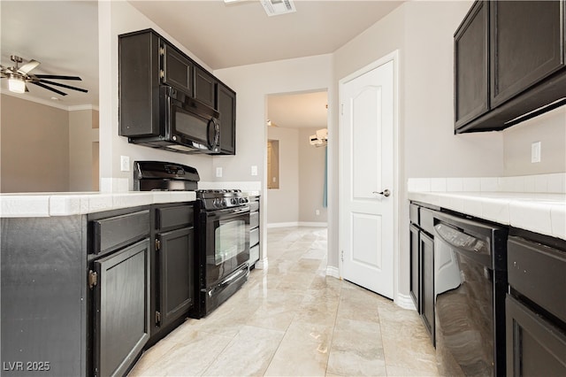 kitchen featuring tile countertops, baseboards, visible vents, ceiling fan, and black appliances