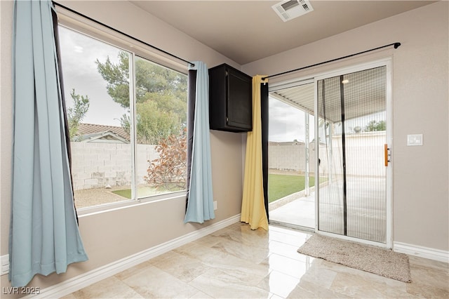 doorway with visible vents and baseboards