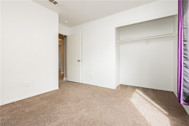 unfurnished bedroom featuring carpet, visible vents, and baseboards