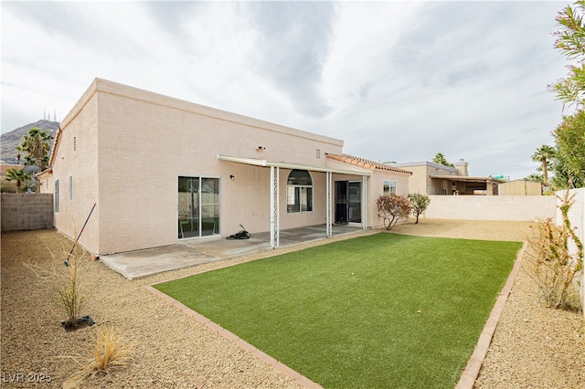 back of property with stucco siding, a patio, and a fenced backyard