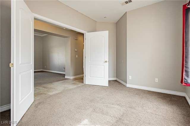 unfurnished bedroom with carpet, visible vents, and baseboards