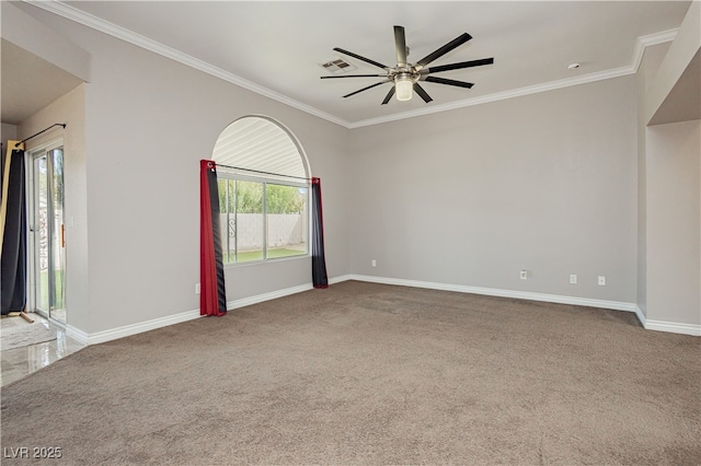 unfurnished room with visible vents, baseboards, crown molding, and carpet