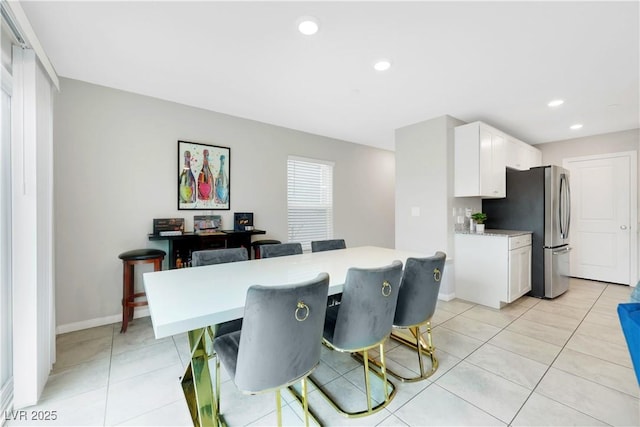 dining area with light tile patterned floors, baseboards, and recessed lighting