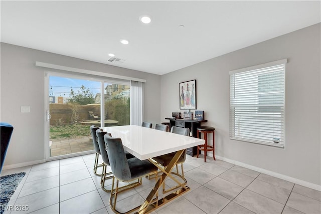 dining area with light tile patterned flooring, visible vents, recessed lighting, and baseboards