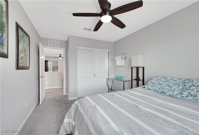 carpeted bedroom featuring visible vents, baseboards, and a closet