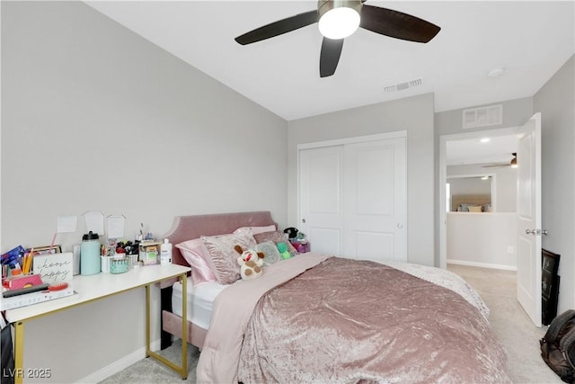 bedroom featuring light carpet, visible vents, and a closet