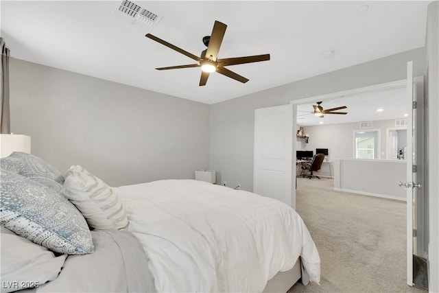 carpeted bedroom featuring baseboards, visible vents, and ceiling fan