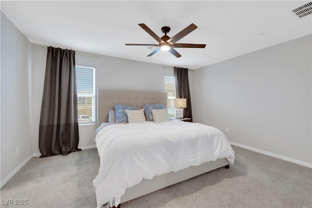 bedroom featuring visible vents, light carpet, baseboards, and ceiling fan