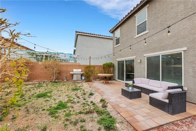 view of patio / terrace with an outdoor hangout area, fence, and a grill