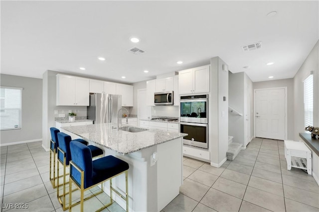 kitchen with a wealth of natural light, visible vents, appliances with stainless steel finishes, and a sink