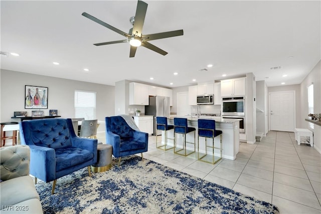 living room featuring visible vents, recessed lighting, light tile patterned flooring, baseboards, and ceiling fan