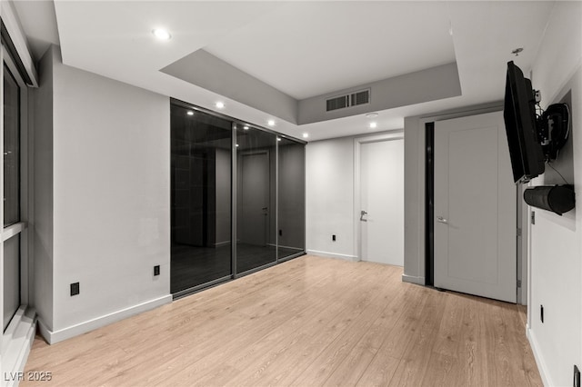 unfurnished bedroom featuring light wood-type flooring, visible vents, baseboards, and recessed lighting