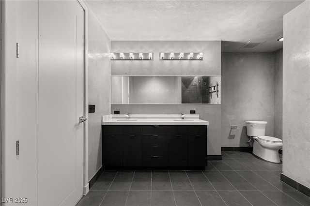 full bath with tile patterned flooring, double vanity, toilet, and a sink