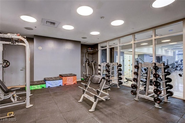 exercise room featuring visible vents and expansive windows