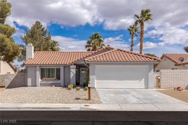 mediterranean / spanish-style home with fence, driveway, an attached garage, stucco siding, and a tile roof