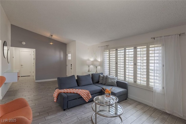 living area with baseboards, lofted ceiling, a textured ceiling, and wood tiled floor