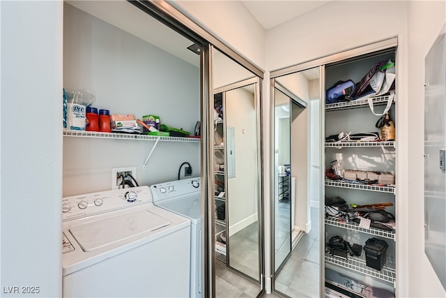 laundry area featuring laundry area, light tile patterned flooring, and washer and clothes dryer