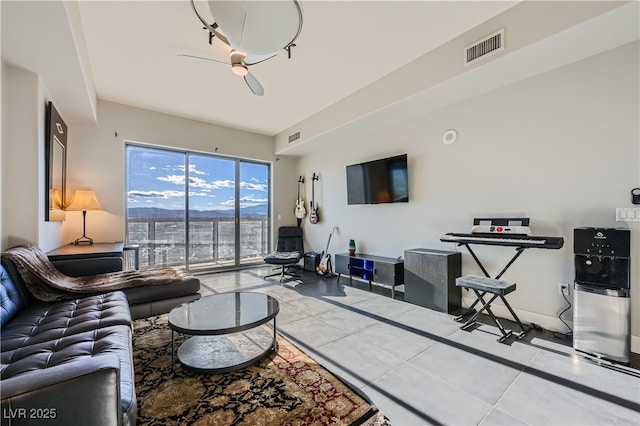 tiled living area with visible vents and ceiling fan