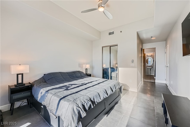 bedroom featuring a closet, visible vents, tile patterned floors, and baseboards