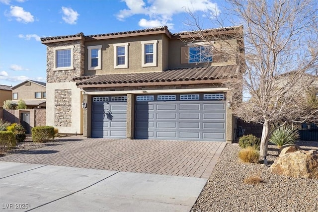 view of front of property featuring a tiled roof, stucco siding, decorative driveway, a garage, and stone siding