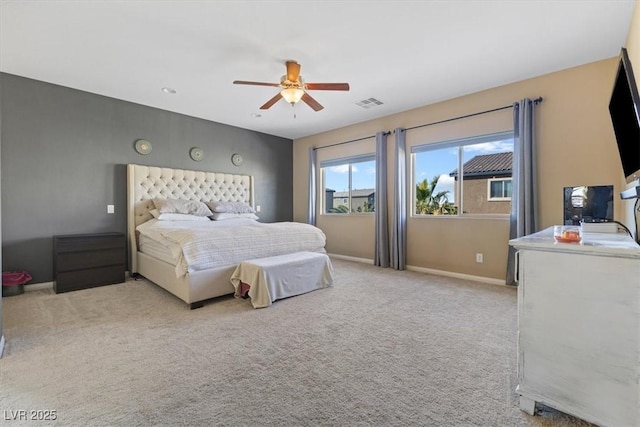 bedroom with light carpet, visible vents, a ceiling fan, and baseboards