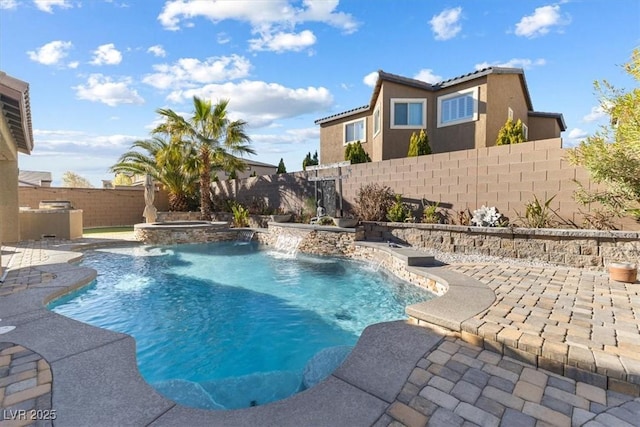 view of swimming pool with a patio area, a pool with connected hot tub, and a fenced backyard