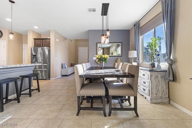 dining space featuring light tile patterned flooring, baseboards, and visible vents