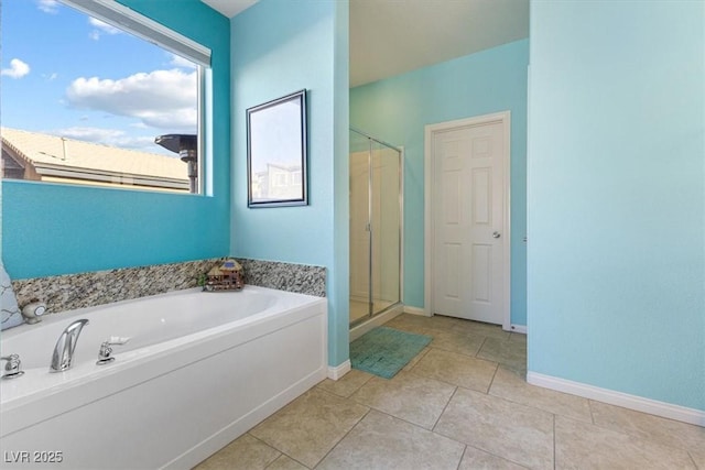 bathroom featuring a bath, tile patterned flooring, a stall shower, and baseboards