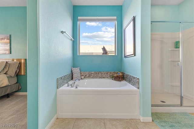 ensuite bathroom with tile patterned floors, a shower stall, and a garden tub