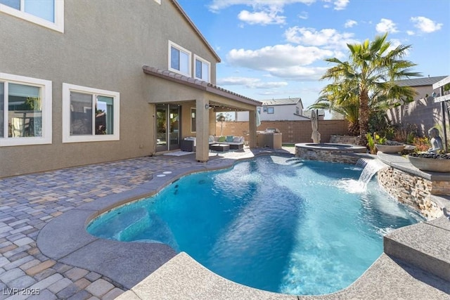 view of pool featuring a patio area, a fenced backyard, a pool with connected hot tub, and an outdoor hangout area