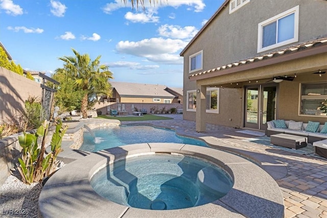 view of swimming pool with an in ground hot tub, a patio area, a fenced backyard, and french doors