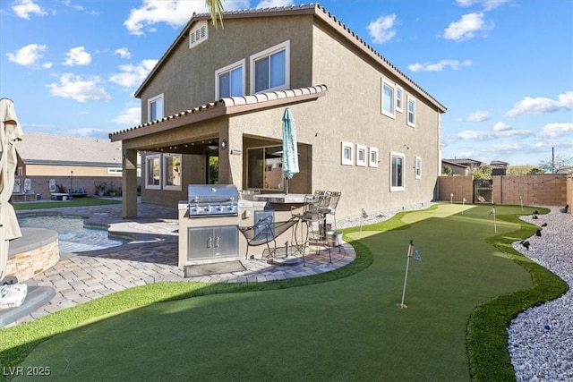 back of property with a patio, area for grilling, a fenced backyard, and stucco siding