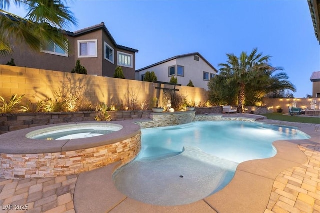 view of pool with a fenced in pool, an in ground hot tub, and a fenced backyard