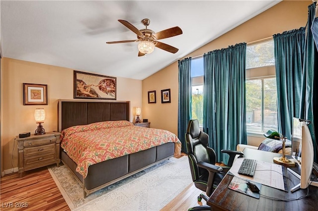 bedroom with baseboards, wood finished floors, a ceiling fan, and vaulted ceiling