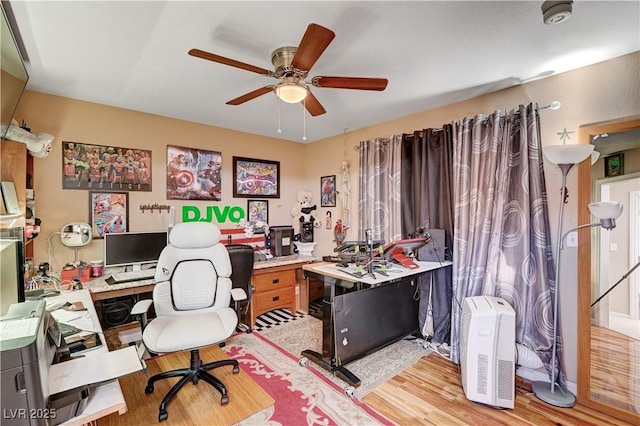 home office with a ceiling fan and light wood-type flooring