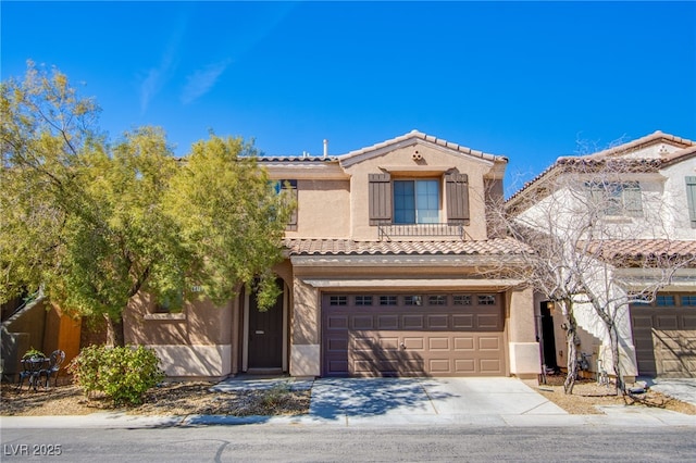 mediterranean / spanish house with stucco siding, concrete driveway, and a tile roof