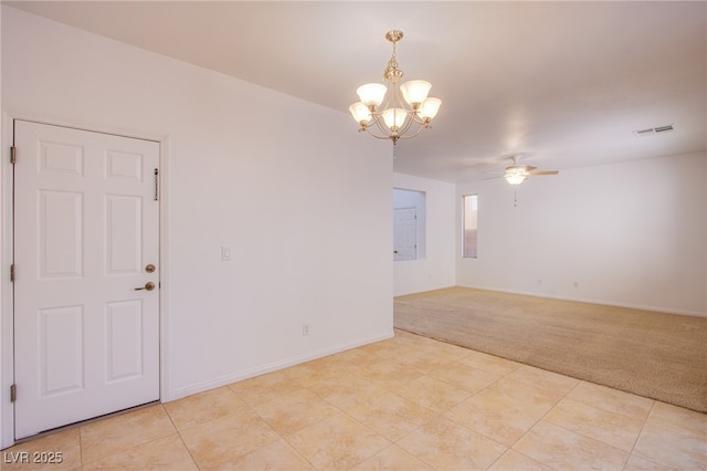 unfurnished room featuring visible vents, baseboards, light carpet, ceiling fan with notable chandelier, and light tile patterned flooring