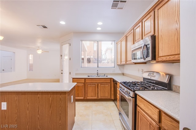 kitchen with light tile patterned flooring, visible vents, stainless steel appliances, and a sink