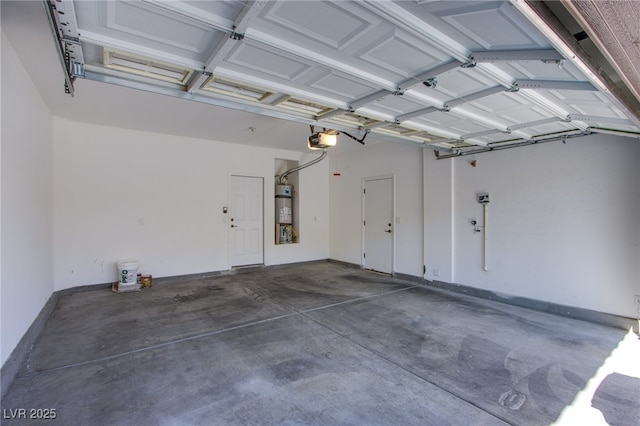 garage with secured water heater and a garage door opener