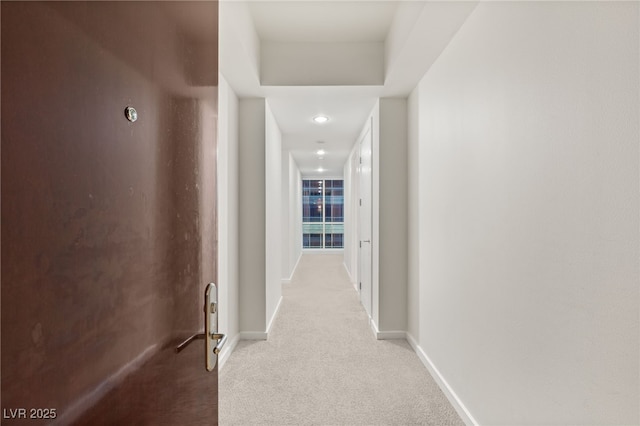 corridor with baseboards and carpet floors