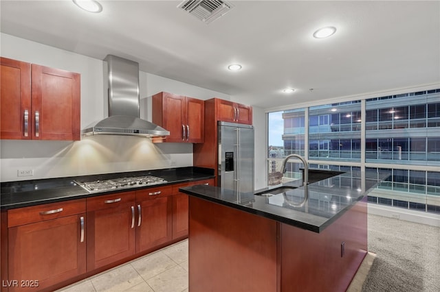 kitchen with visible vents, wall chimney range hood, recessed lighting, appliances with stainless steel finishes, and a sink