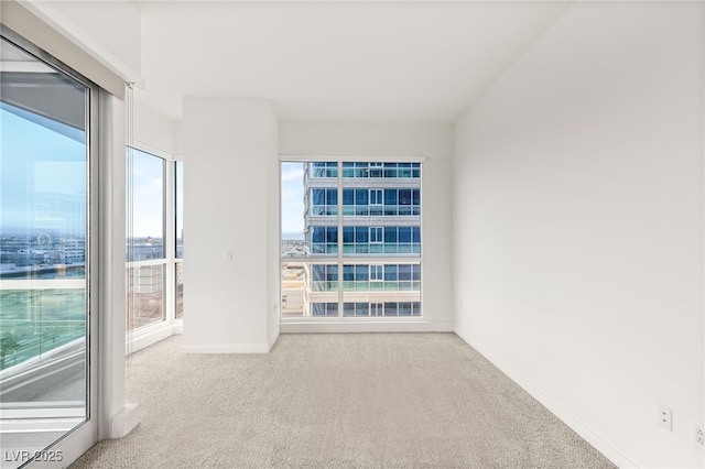 unfurnished room featuring baseboards and carpet floors