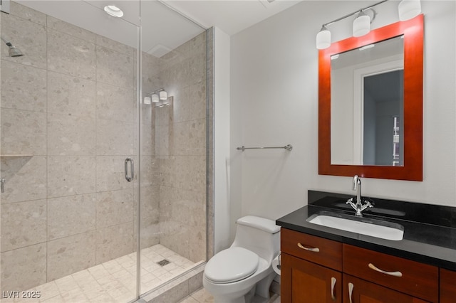 full bath with vanity, a shower stall, and toilet