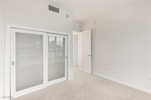 unfurnished bedroom with visible vents, baseboards, and carpet floors