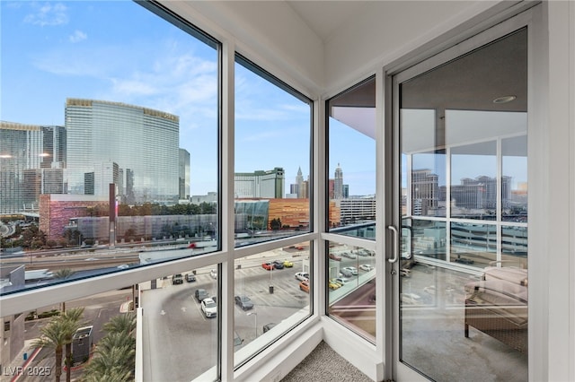 unfurnished sunroom featuring a view of city