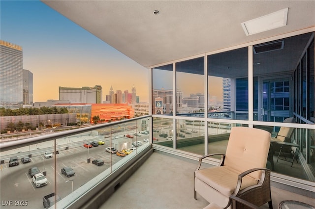 balcony at dusk with a view of city