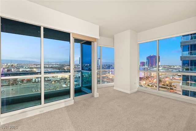 carpeted empty room featuring a view of city