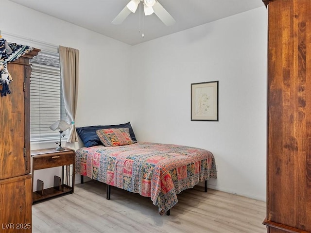 bedroom featuring ceiling fan, baseboards, and light wood-style floors