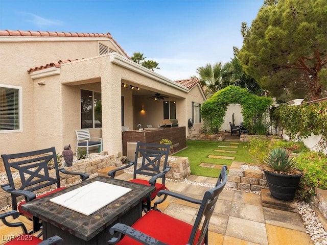 view of patio featuring ceiling fan