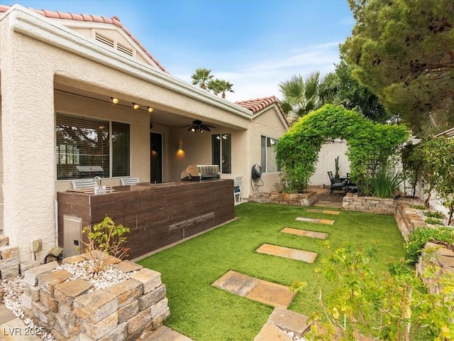 view of yard with a patio, ceiling fan, and fence